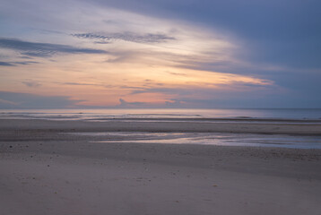 Fototapeta na wymiar Early morning sunrise over the sea. Beach, Copy space, Selective focus.