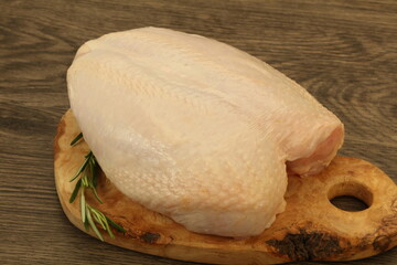 Raw whole chicken breast with skin