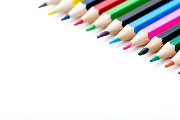 School stationery items. Creation Multicolored pencils on a blank white sheet. On a white background. Children's drawing, artist.