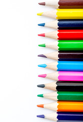 School stationery items. Creation Multicolored pencils on a blank white sheet. On a white background. Children's drawing, artist.