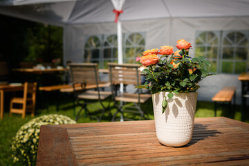 Flowers standing on a wooden table outdoors