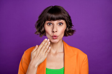 Photo of impressed millennial brunette lady hand lips wear orange cardigan isolated on violet color background