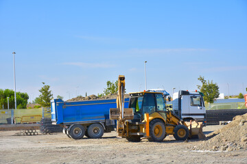 large yellow shovel and  backhoe 