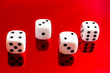 Group of white dice reflected in red background