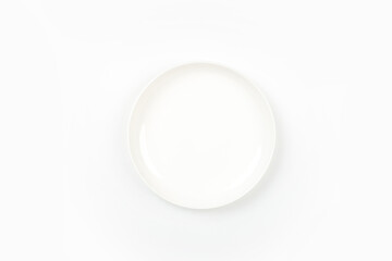 White plate placed on a white background, top view