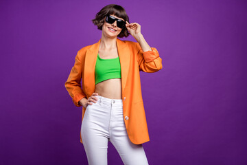 Photo of cool young brunette lady wear orange blazer top eyewear isolated on violet color background