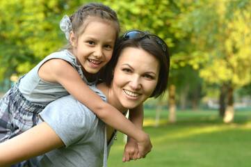 Portrait of happy mother and daughter smiling outdoors