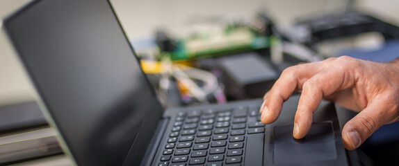 Closeup detail view of laptop computer. Engineer inspect electric system
