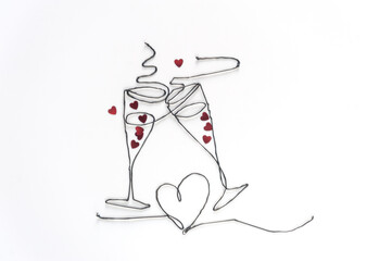 Two glasses with sparkling wine with hearts on white background. Abstract background for greeting card, poster. Valentines day concept. Flat lay, top view, copy space, soft focus.