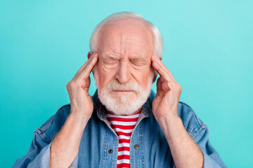 Portrait of attractive depressed grey-haired man touching temples feeling bad isolated over bright...