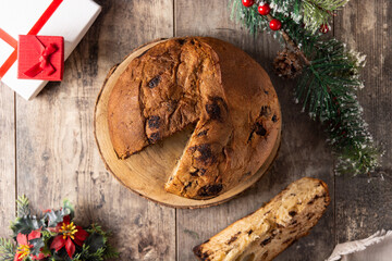 Traditional Italian panettone for Christmas on rustic wooden table	