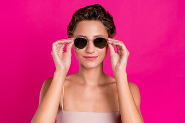 Photo of positive cool cheerful young lady wear sunglass charming face isolated on magenta color background