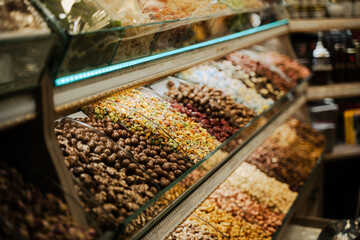 rows of candy assortments lined up in the window of a sweet shop