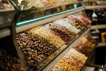 rows of candy assortments lined up in the window of a sweet shop