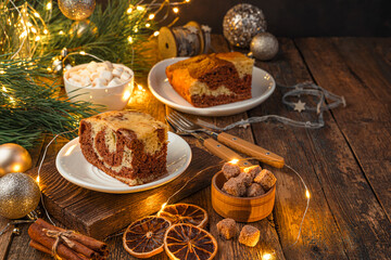 Festive cake on a Christmas background with lights. The concept of Christmas and New Year.
