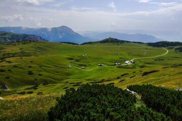 Fototapeta na wymiar amazing green nature landscape with alpine huts and paths