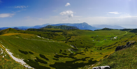 amazing green nature landscape with alpine huts and paths in the mountains panorama