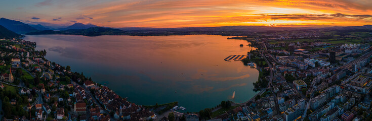 Beautiful sunset over Swiss lake and city of Zug