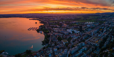 Swiss city by the lake at early evening, drone shot