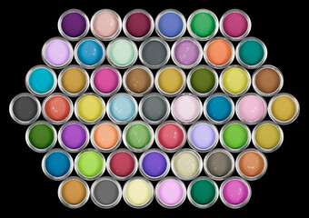 Tins of paint in pastel and muted colors.