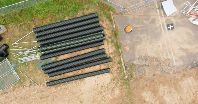 PVC tubes plastic pipes stacked in rows at a construction site on reconstruction of the city drain system