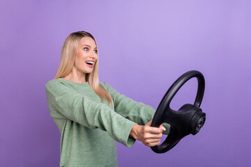 Profile side photo of young excited girl rider automobile fast speed wondered isolated over purple color background