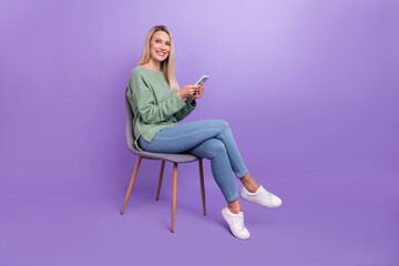 Profile side photo of mature woman use smartphone social network type sms sit stool isolated over...