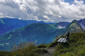 wooden bench on the top from a mountain with wonderful view
