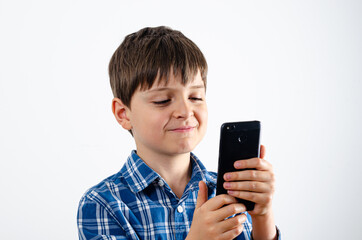 Kid looks at smartphone with smile