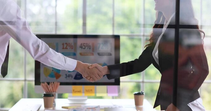 Two Caucasian business people, male and female, taking business topic and get final finished with agreed and success and then making handshake in concept of perfect work dealing.