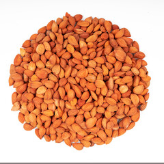 Dry apricot kernel pits on white isolate.