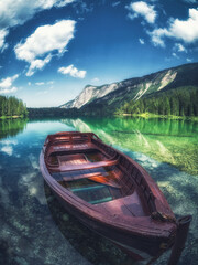Red boat in a lake surround by mountains