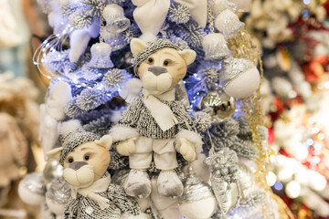 Close up of holidays location with soft tiger toys and garlands on blue white Christmas tree