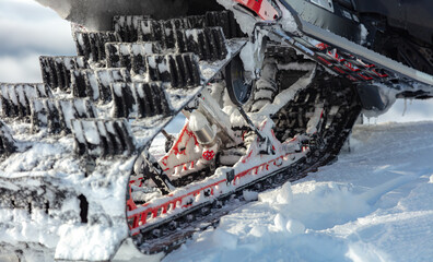 a truck of a sports snowmobile in close-up against the background of a mountain valley. the concept of recreation on a mountain snowmobile in winter