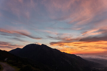 Clouds descend over Playa de la Isla at sunset. Asturias. Spain
