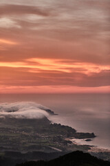 Naklejka na ściany i meble Clouds descend over Playa de la Isla at sunset. Asturias. Spain