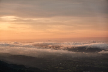 Clouds descend over Playa de la Isla at sunset. Asturias. Spain