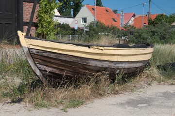 Fototapeta na wymiar Old wooden fishing boat in the grass.