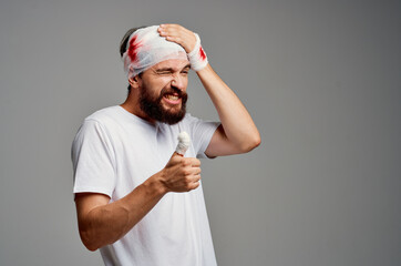 Man in a white t-shirt trauma health diagnosis light background