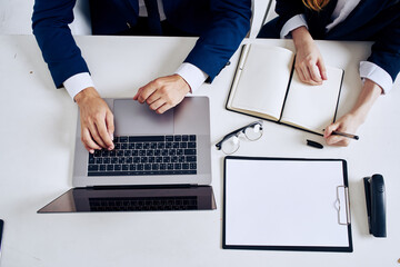 colleagues laptop and documents on the table technology