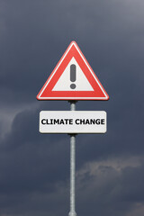 A sign with a exclamation mark warning for a dangerous situation ahead and a smaller sign below with the English text Climate Change on it