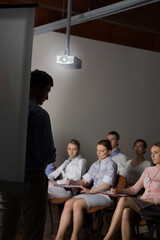 Man at projection screen at business conference