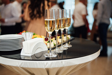 glasses with champagne and fruits on buffet table at a restaurant or in the hotel lobby