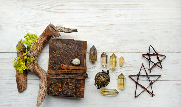 minerals, incense burner, witch book, pentacle, Magical items on white wooden background. esoteric concept. witchcraft,  wiccan spiritual esoteric occult practice. healing crystal ritual. top view