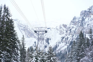 beautiful winter landscape with snowy mountains, Swiss Alps, snowfall in forest, iron construction...