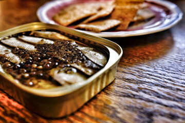 A can of sardines with some crackers
