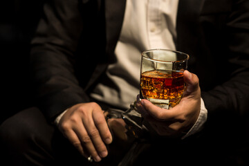 Closeup businessmen holding a glass of whiskey