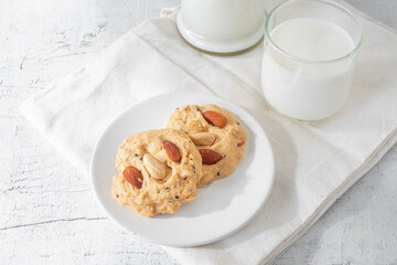 cookies and milk on white wooden background