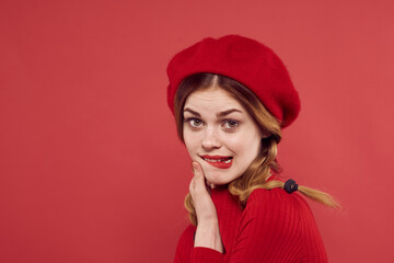 pretty woman in a red sweater cosmetics emotion studio posing