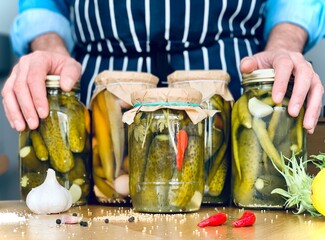 Artisanal. A man is doing pickles jars stock for winter season. Organic homemade cucumber pickles....